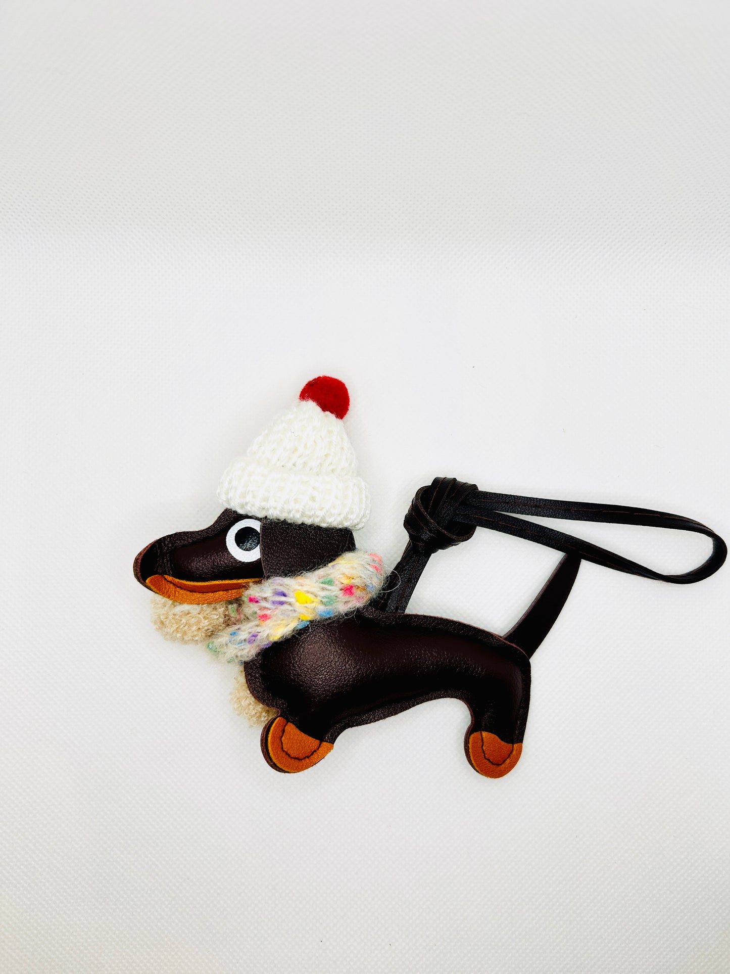Dachshund winter edition keychain. Cute faux leather cartoon dog design.