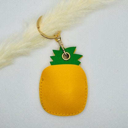 Porte-clés ananas en similicuir. Accessoire estival avec un compartiment pour AirTag ou pièces de monnaie.