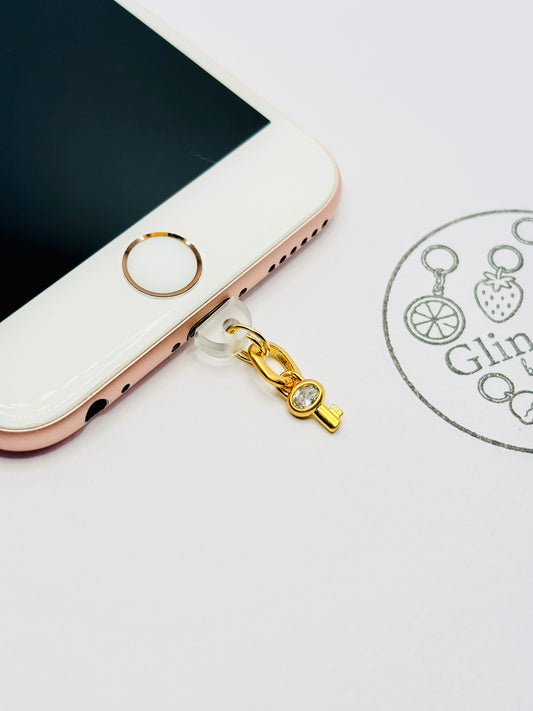 Schlüssel Handy Charm. Symbol für Vertrauen und Verbindung.