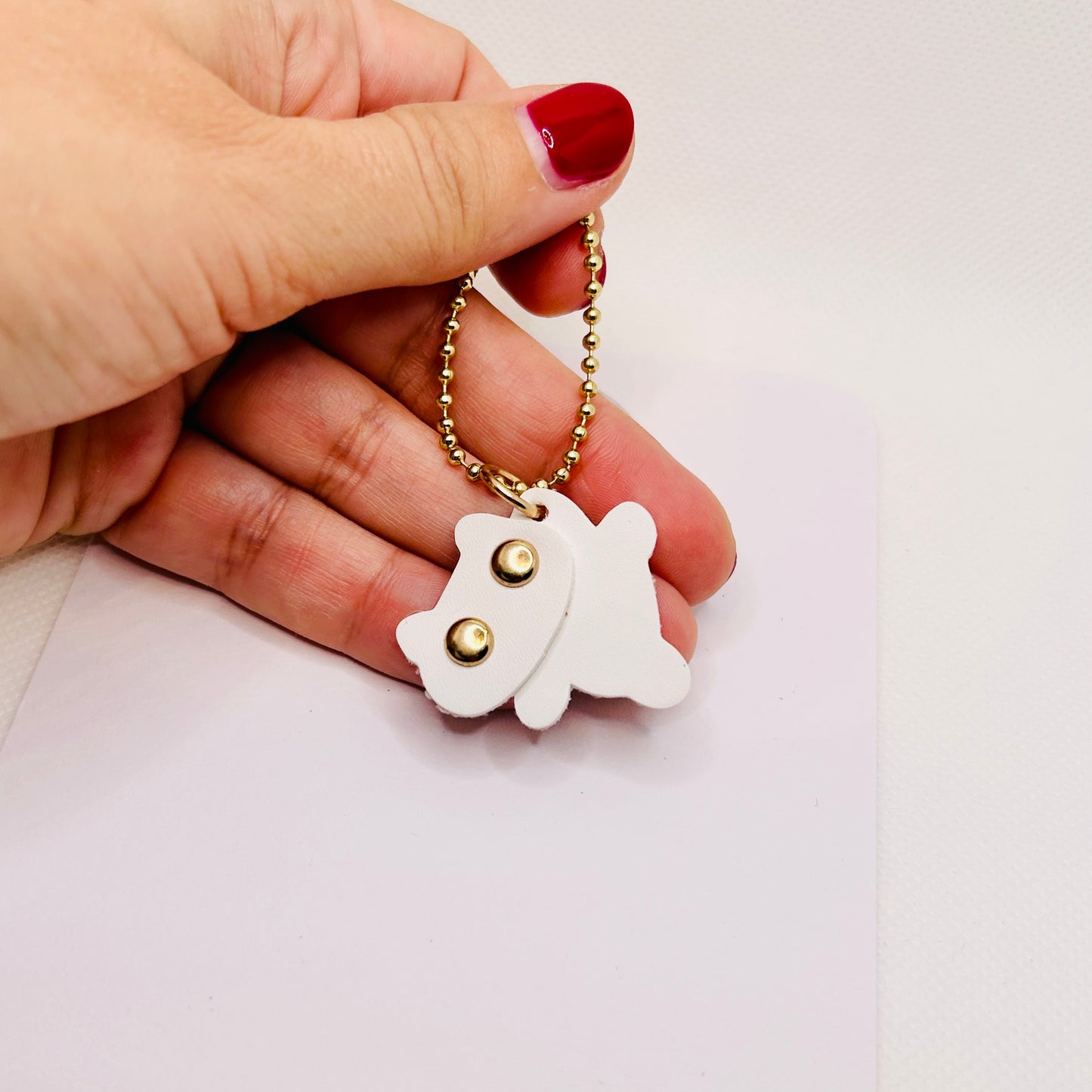 Minimalistischer Katzen Schlüsselanhänger aus Kunstleder. Modernes Design mit goldener Kugelkette.